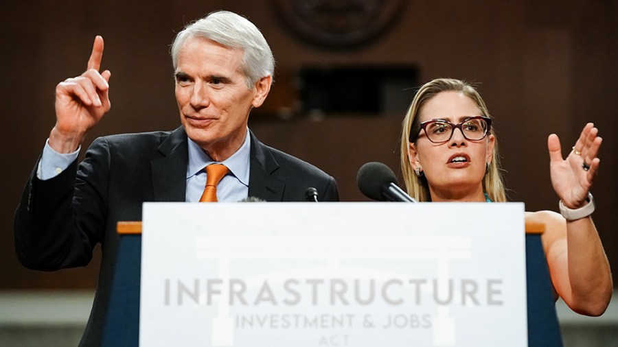 Sens. Rob Portman (R-Ohio) and Kyrsten Sinema (D-Ariz.) addresses reporter after a key vote regarding the bipartisan infrastructure legislation on Wednesday, July 28, 2021.