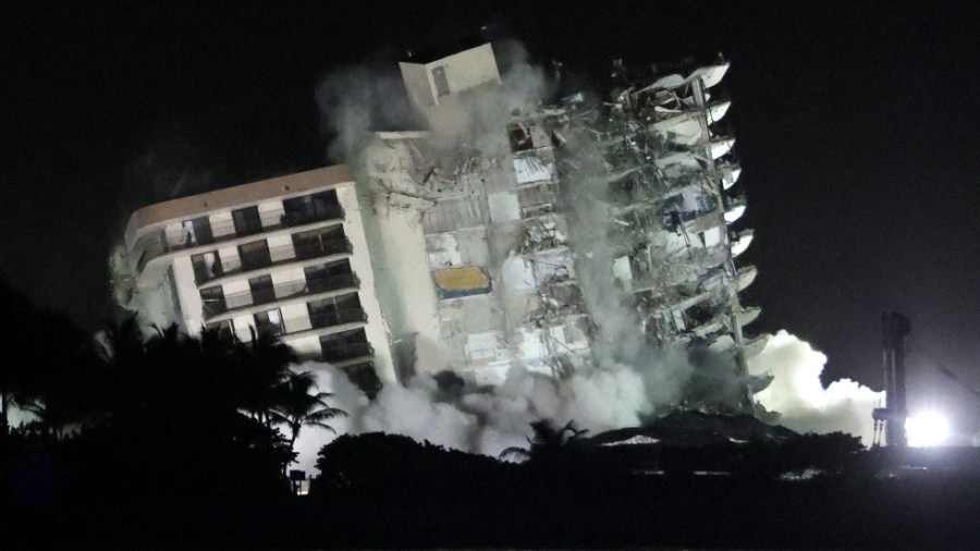 The remainder of the partially collapsed 12-story Champlain Towers South condo building in Surfside, Fla. falls under a controlled demolition