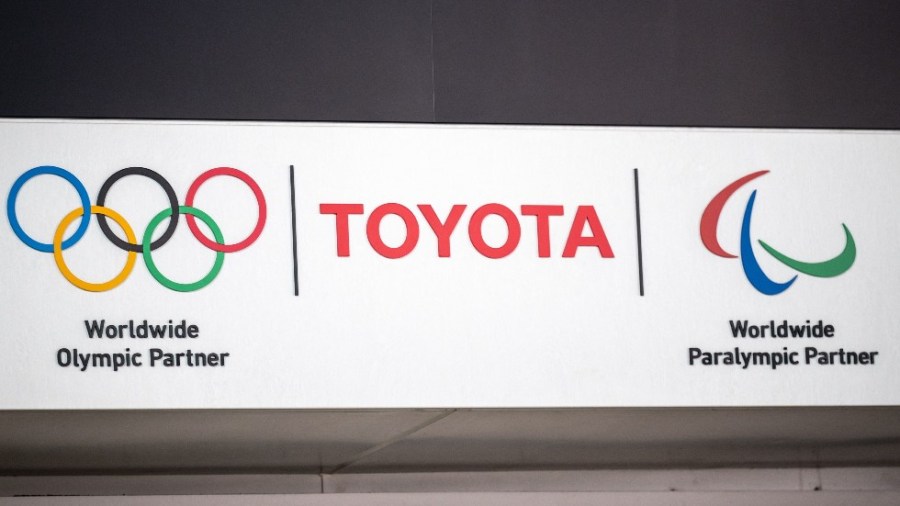 A sign with Toyota and Olympic and Paralympic games logos at a closed Toyota showroom in Tokyo.