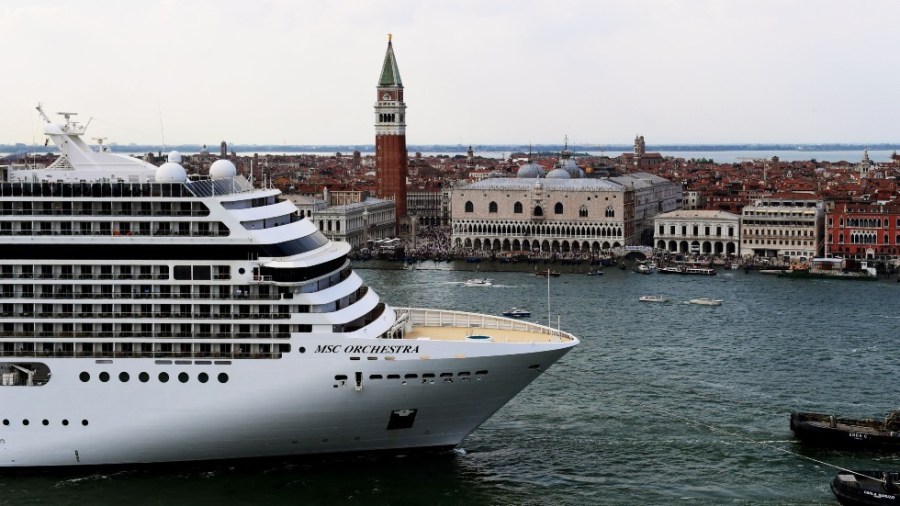 A cruise ship departs Venice