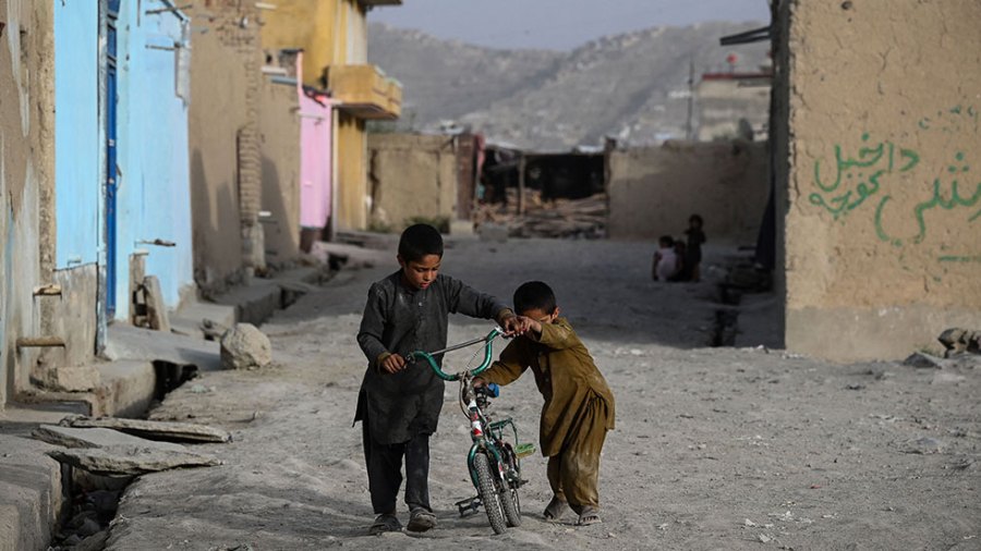 Children ride a bike in Afghanistan