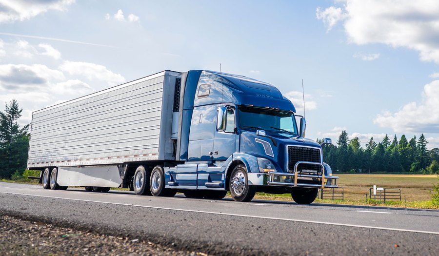 Blue truck driving on the road