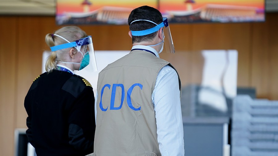 A Center for Disease Control official is seen as Afghans displaced from their homes due to the Taliban takeover arrive at Washington Dulles International Airport in Chantilly, Va. on Monday, August 30, 2021.