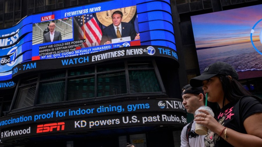 A screen in Times Square shows news coverage of New York Gov. Andrew Cuomo following a new report on allegations of sexual harassment against him