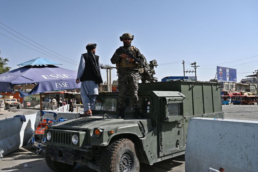 Taliban fighters guard a gate a Kabul airport