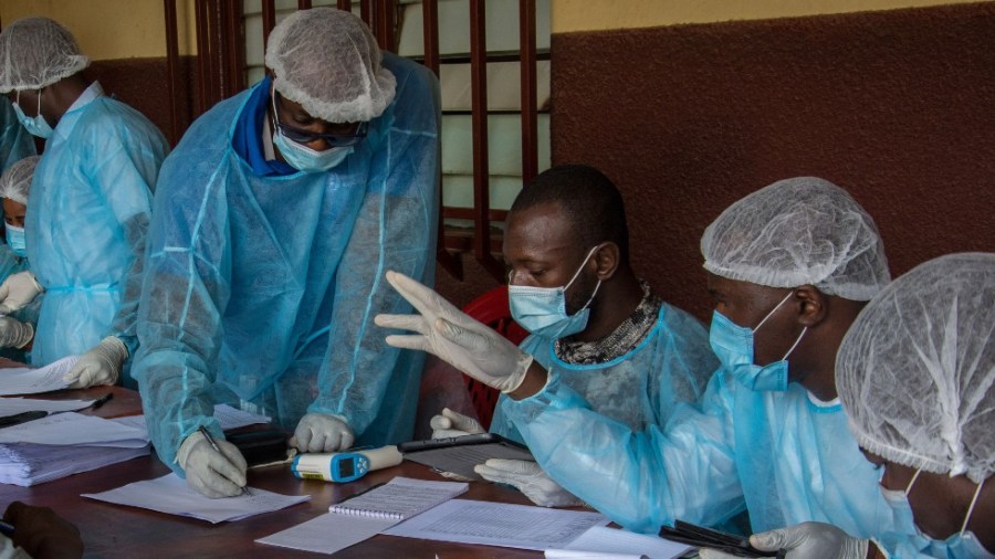 Health workers from the Guinean Ministry of Health prepare forms to register medical staff ahead of their anti-ebola vaccines at the N'zerekore Hospital