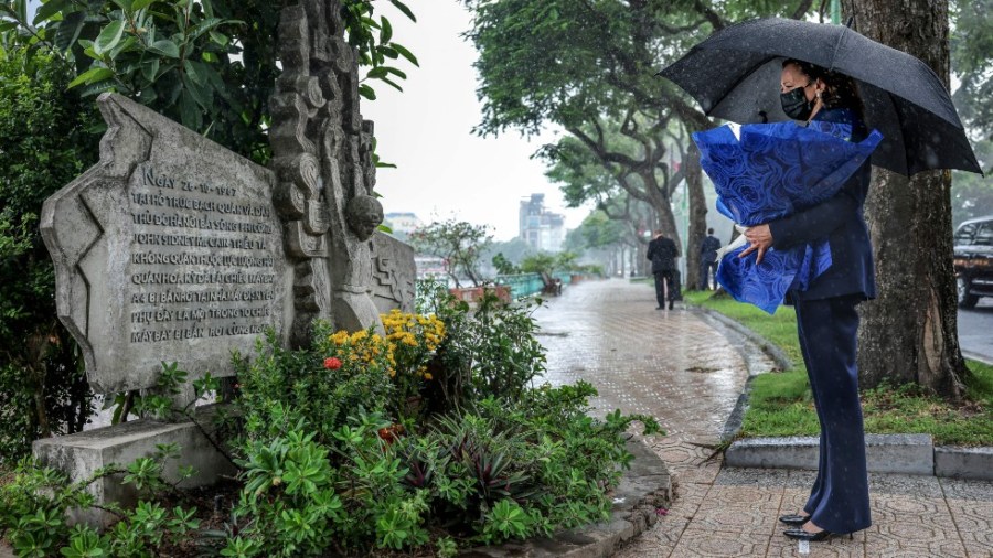 Vice President Kamala Harris lays flowers at the Senator John McCain memorial site in Hanoi