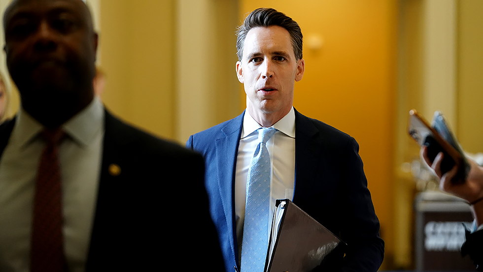 Sen. Josh Hawley (R-Mo.) leaves a meeting with Senate Republicans to discuss the bipartisan infrastructure bill on Wednesday, July 28, 2021.