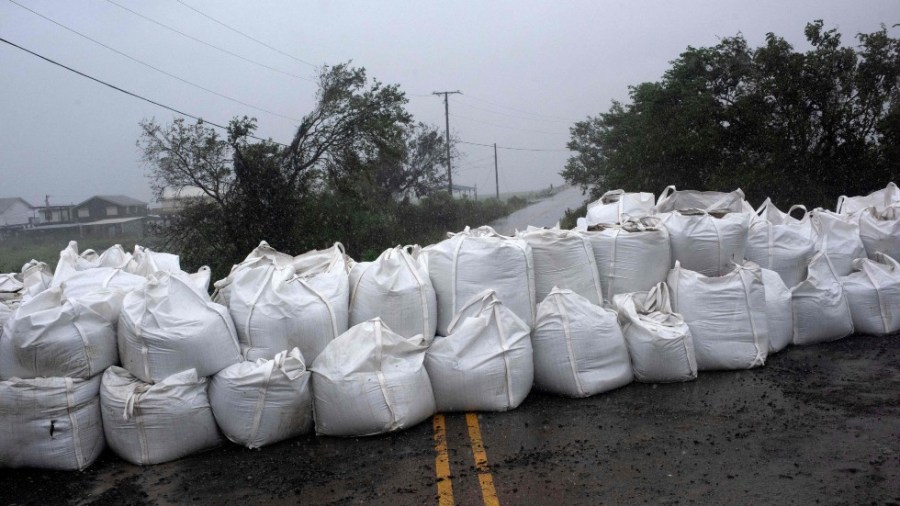 Rain comes down at a wall of sandbags in Montegut, Louisiana