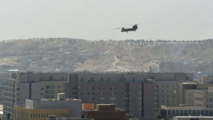 A military helicopter files over Kabul