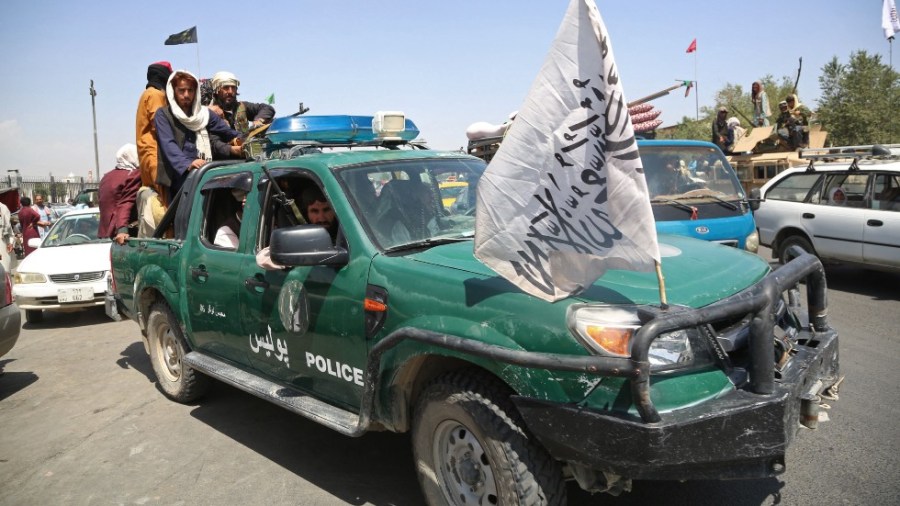 Armed Taliban fighters ride through Kabul