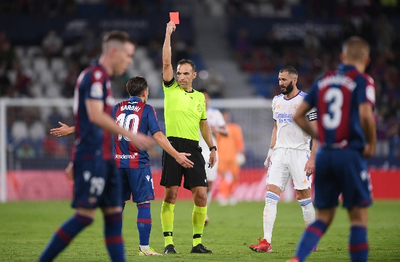 Referee Guillermo Cuadra Fernandez shows a red card to Aitor Fernandez of Levante