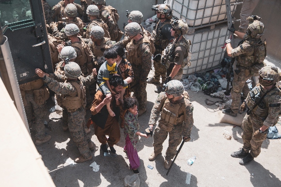 U.S. Marines and Norwegian coalition forces assist with security at the airport in Kabul