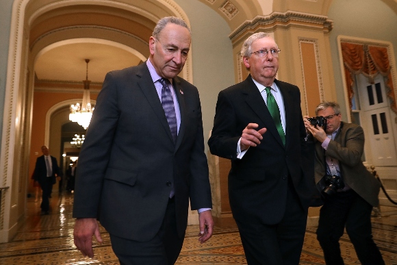 Senate Minority Leader Charles Schumer (D-NY) (L) and Senate Majority Leader Mitch McConnell (R-KY) walk side-by-side to the Senate Chamber