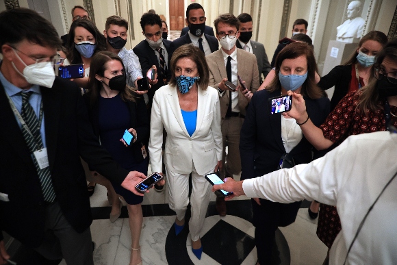 Speaker Nancy Pelosi (D-CA) (C) is surrounded by reporters and staff