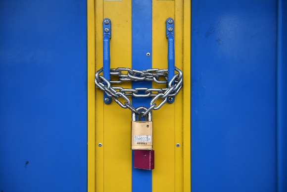 The doors of Brixton Underground station are locked with a padlock