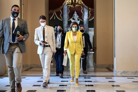 Speaker Nancy Pelosi (D-CA) speaks to a reporter as she walks to the floor of the House Chambers