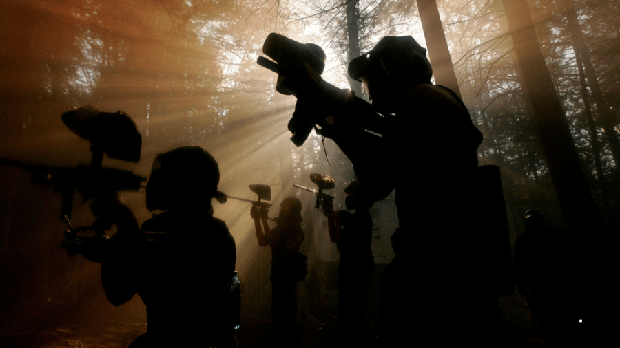 Paintballers advance through the woods in Jim Thorpe, Pa.