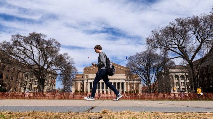 A student walks on the University of Minnesota campus