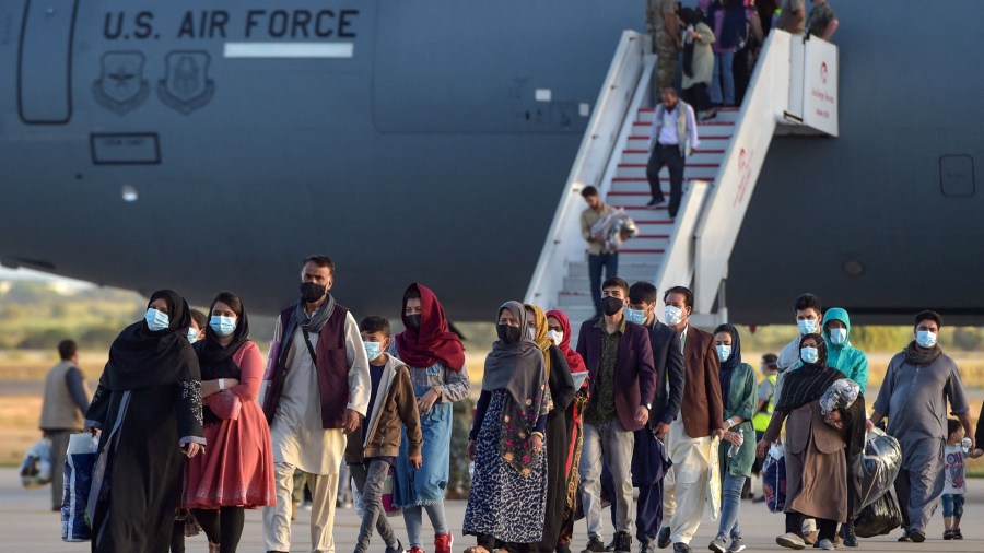 Afghan refugees arrive at a US military base