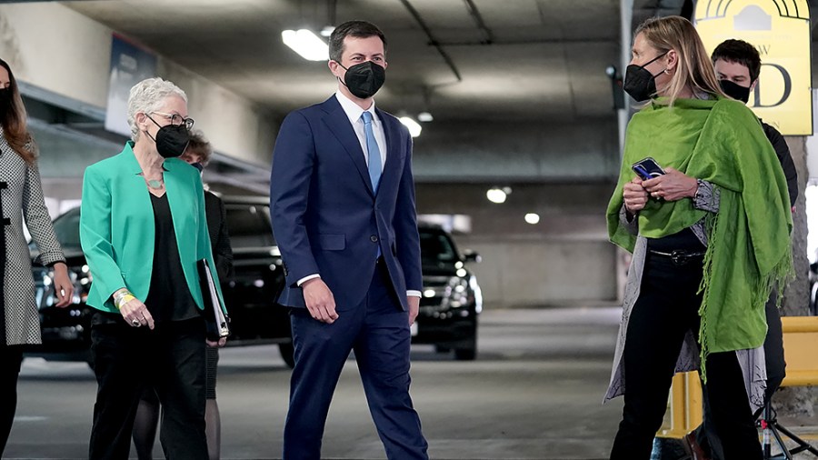 National Climate Advisor Gina McCarthy and Secretary of Transportation Pete Buttigieg speaks to EVgo CEO Cathy Zoi before a press conference in front of an EVgo charging station at Union Station in Washington, D.C., on Thursday, April 22, 2021.