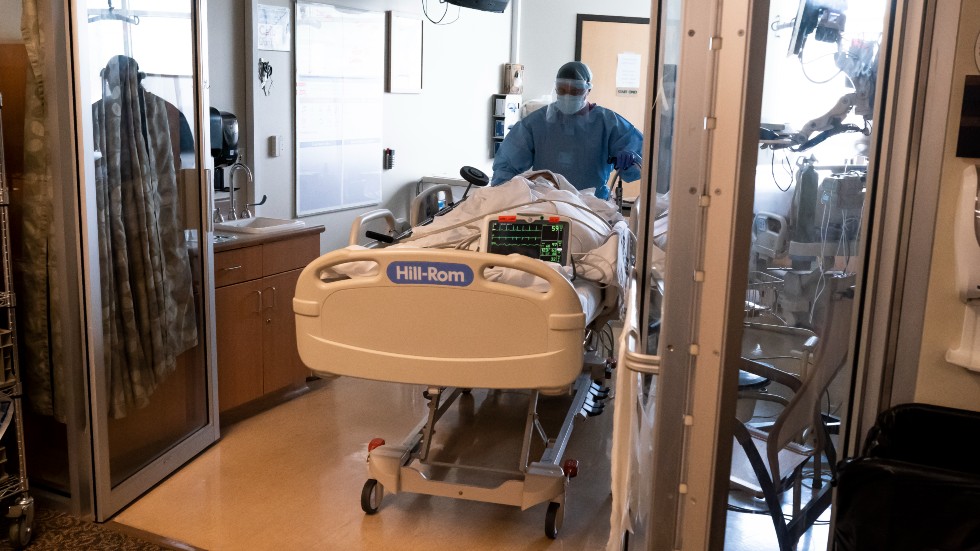 Medical staff move a COVID-19 patient from the emergency room into the COVID-19 Intensive Care Unit 