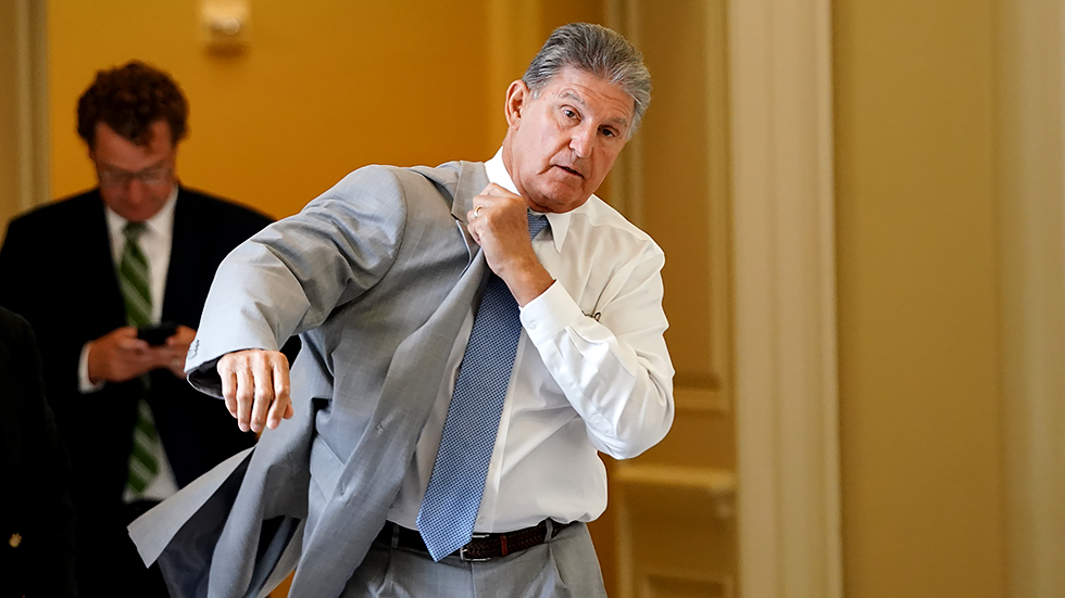 Sen. Joe Manchin (D-W.Va.) leaves the weekly Senate Democratic policy luncheon on Tuesday, July 20, 2021.