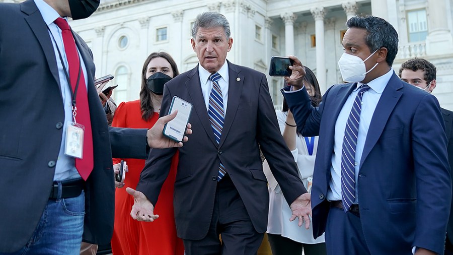 Sen. Joe Manchin (D-W.Va.) speaks to reporters as he leaves the Capitol after a cloture vote to fund the government and suspend the debt ceiling on Monday, September 27, 2021.