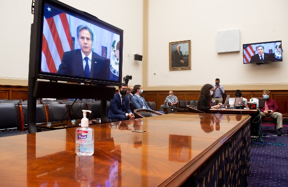 US Secretary of State Antony Blinken appears on a television screen as he testifies virtually