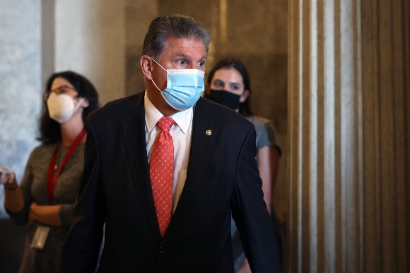 Sen. Joe Manchin (D-WV) walks to a Democratic policy luncheon at the U.S. Capitol