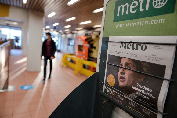 A newspaper shows a cover photo of Canadian Prime Minister Justin Trudeau