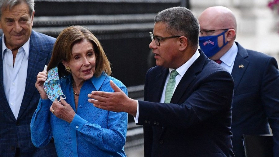 COP26 official Alok Sharma accompanies Speaker Nancy Pelosi (D-Calif.) as they walk up Downing Street in London