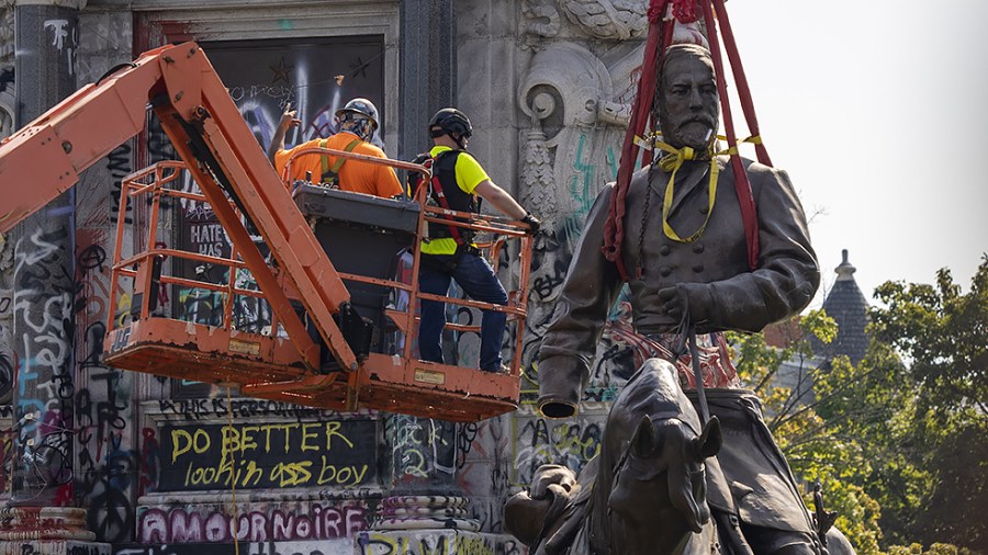 Workers with Team Henry Enterprises dismantle the statue of Gen. Robert E. Lee in Richmond, Va., on Wednesday, September 8, 2021.