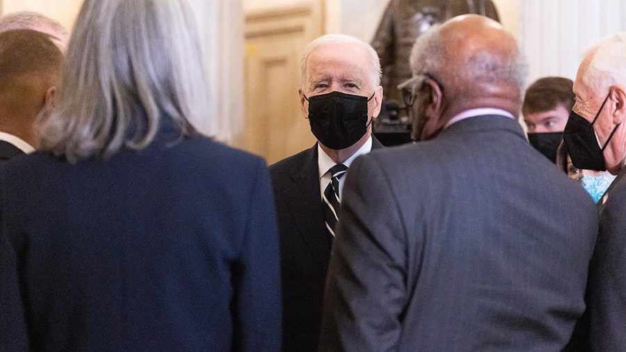 President Biden speaks with House Majority Whip James Clyburn (D-S.C.) and House Majority Leader Steny Hoyer (D-Md.) before a House Democratic Caucus meeting to discuss the Build Back Better agenda and the bipartisan infrastructure deal on Oct. 28, 2021.