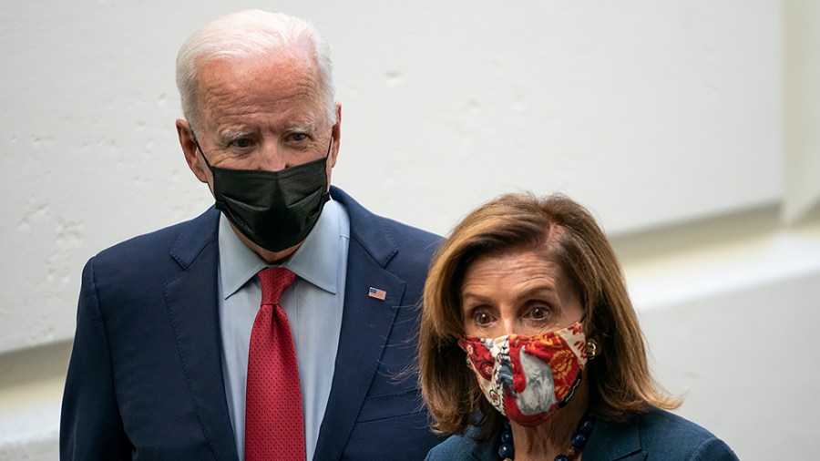 President Biden listens to Speaker Nancy Pelosi (D-Calif.) after a Democratic Caucus meeting at the Capitol to discuss the bipartisan infrastructure plan on Friday, October 1, 2021.