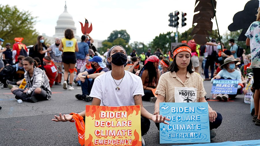 Climate protesters stage a sit-in outside the U.S. Capitol on Friday, October 15, 2021. The group ‘People vs Fossil Fuels’ want President Biden to end fossil fuel projects and to declare climate change a national emergency.