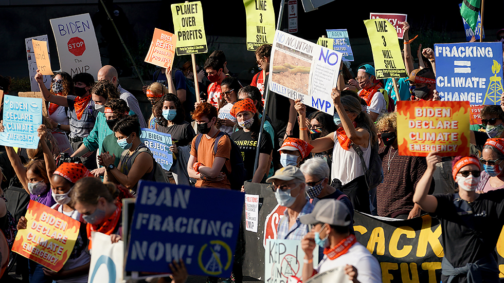 Climate protesters march down Pennsylvania Ave. on their way to the Capitol on Friday, October 15, 2021. The group ‘People vs Fossil Fuels’ want President Biden to end fossil fuel projects and to declare climate change a national emergency.