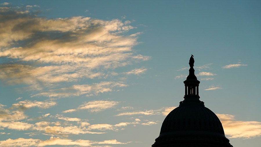 The Capitol is seen from the Capitol Reflecting Pool at sunrise on Tuesday, October 26, 2021.