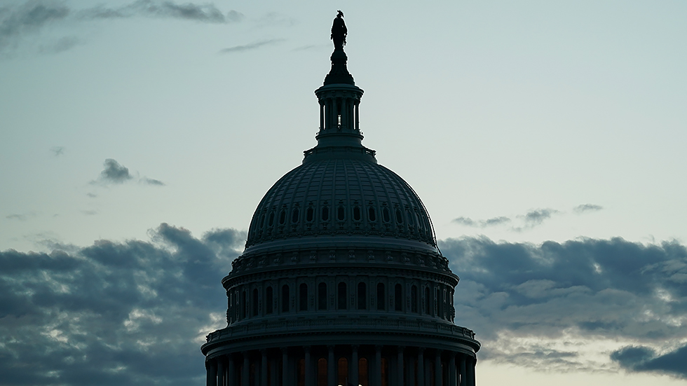 The Capitol is seen from the Capitol Reflecting Pool at sunrise on Tuesday, October 26, 2021.