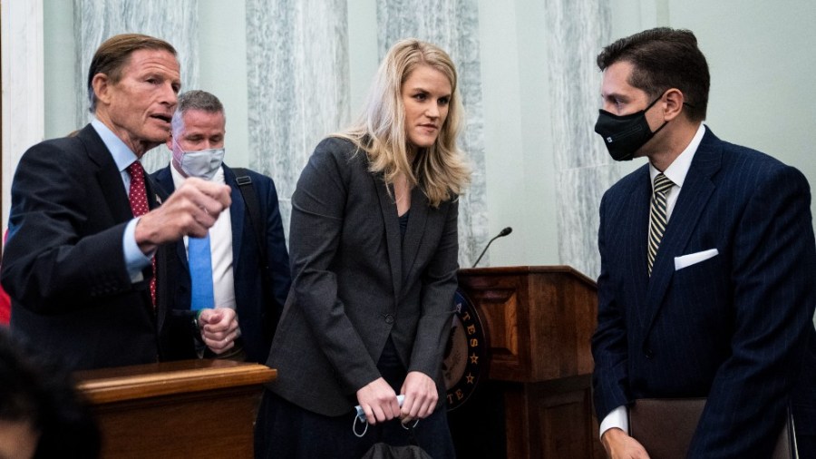 Former Facebook employee and whistleblower Frances Haugen (C) is welcomed by US Senator Richard Blumenthal (L) at hearing.