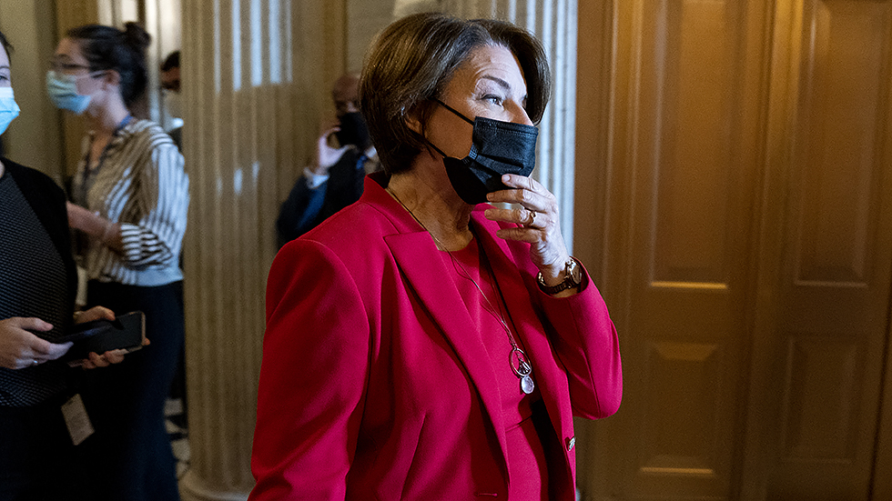 A. Klobuchar (D-Minn.) leaves the Senate Chamber for a nomination vote on Tuesday, October 5, 2021.