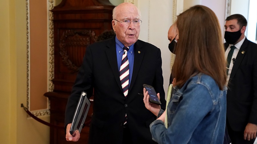 Sen. Patrick Leahy (D-Vt.) speaks to a reporter as he heads to the Senate Chamber for a vote following a Democratic Caucus luncheon on Thursday, September 30, 2021.