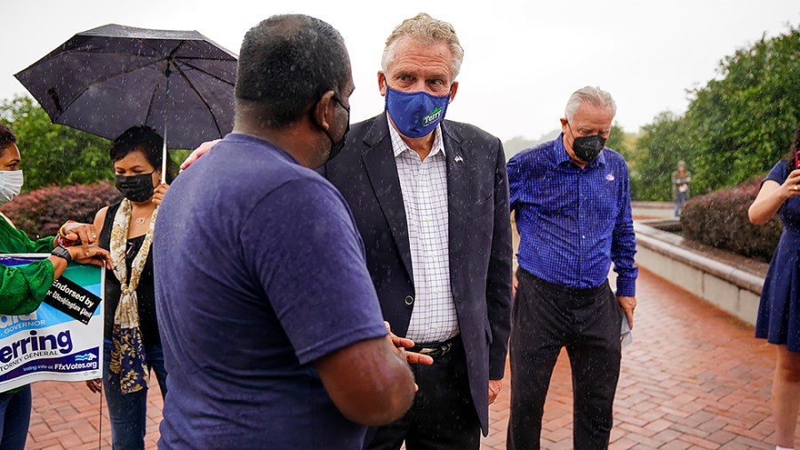 Virginia Democratic gubernatorial candidate Terry McAuliffe greets supporters at a campaign stop outside the Fairfax County Government Center in Fairfax, Va., as the state opens the polls for the first day of early voting on Friday, September 17, 2021.