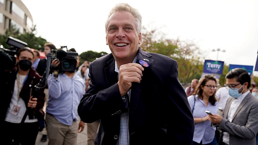 Virginia Democratic gubernatorial candidate Terry McAuliffe celebrates after casting his ballot during early voting at the Fairfax County Government Center in Fairfax, Va., on Wednesday, October 13, 2021.