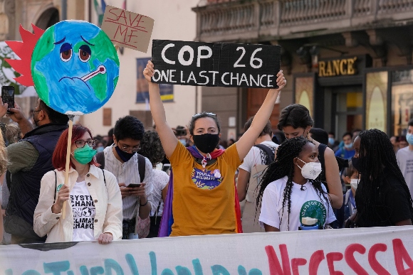 Climate activist Vanessa Nakate, of Uganda, right, gathers with demonstrators