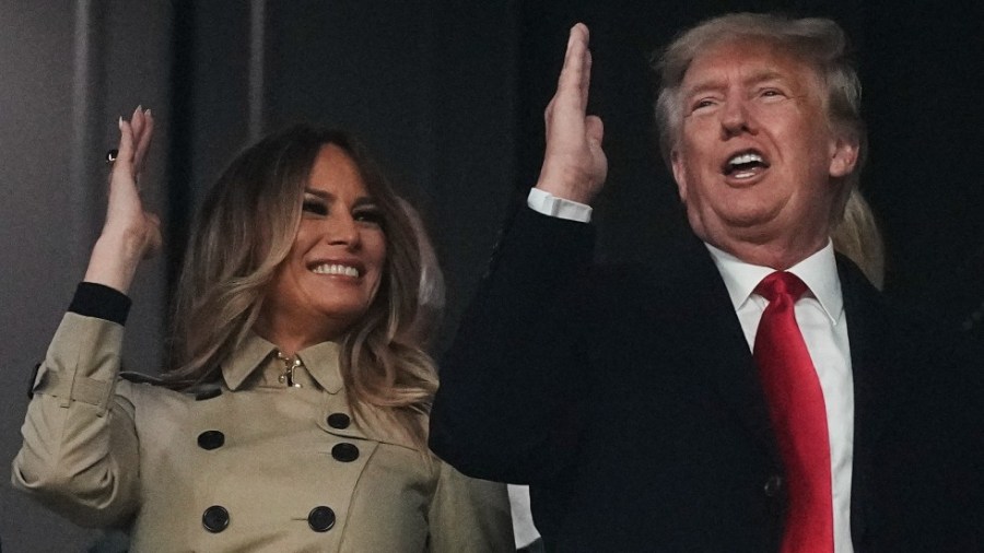 Former President Donald Trump and his wife Melania perform the tomahawk chop before for Game 4 of baseball's World Series