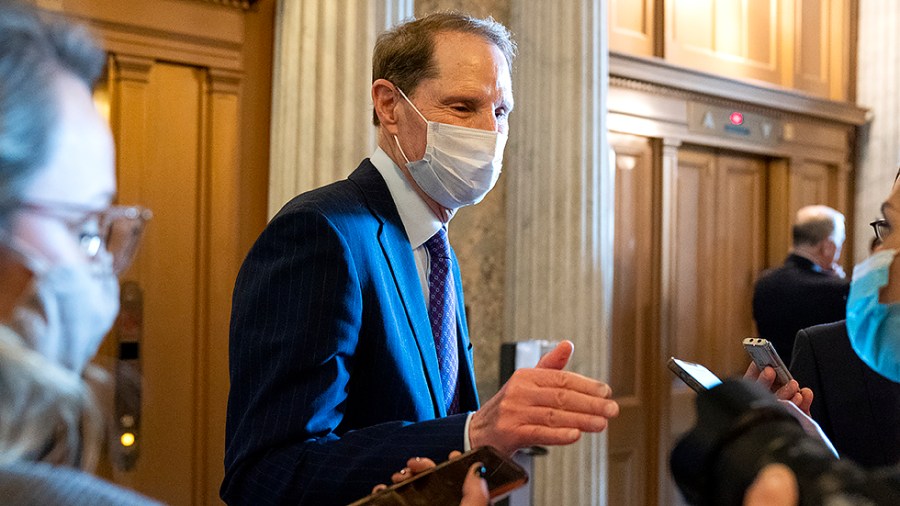 Sen. Ron Wyden (D-Ore.) speaks to reporters as he arrives to the Senate Chamber for a nomination vote on Tuesday, October 5, 2021.