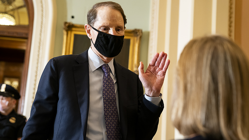 Sen. R Wyden (D-Ore.) speaks to a reporter before the weekly Senate Democratic policy luncheon on Tuesday, October 19, 2021.