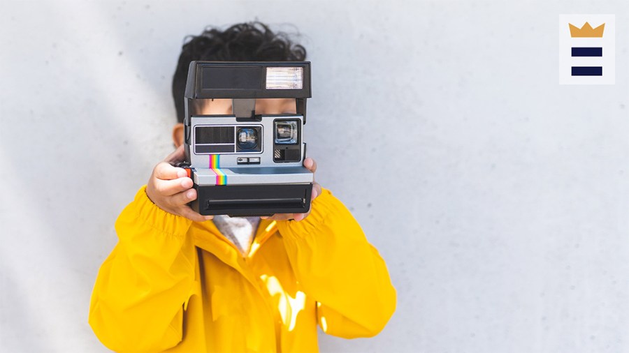 little kid with polaroid camera