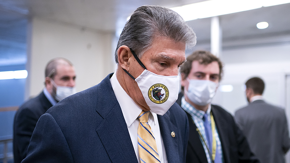 Sen. J Manchin (D-W.Va.) speaks to reporters as he arrives to the Capitol for a vote on Wednesday, November 17, 2021.